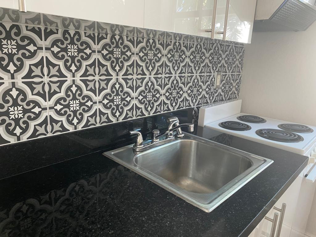 320 80th Street, Unit 15 Miami Beach, FL 33141 - Photo 6 of 18 a close view of sink and tap