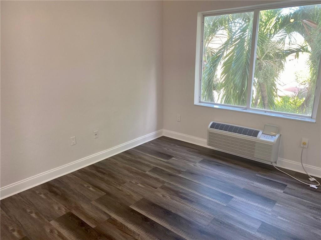 320 80th Street, Unit 15 Miami Beach, FL 33141 - Photo 8 of 18 a view of a room with wooden floor and window