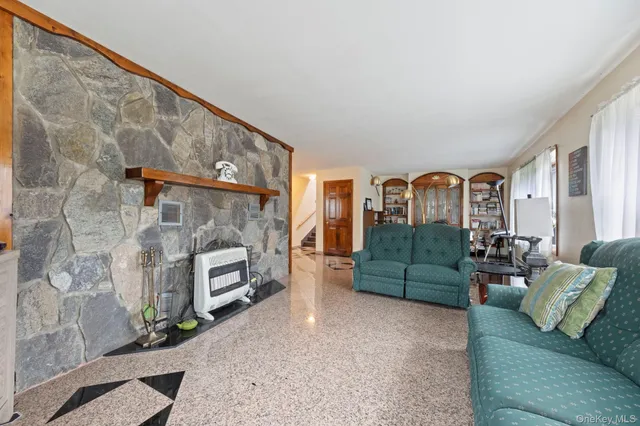 a view of a dining room with furniture and a window