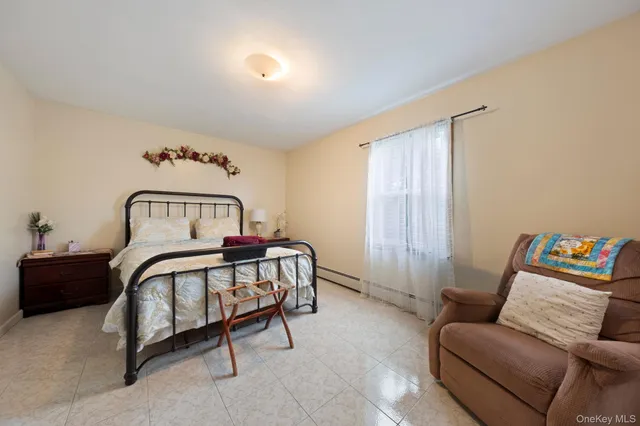 a bedroom with a bed couch and window