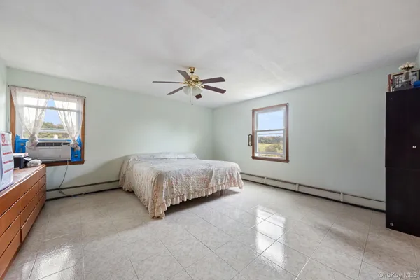 a bedroom with a bed and a painting on the wall