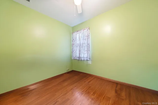 an aerial view of green landscape with trees houses and mountain view