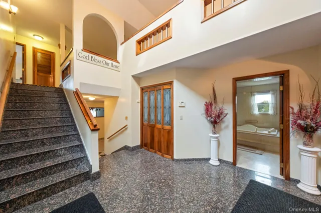 a view of entryway and hall with wooden floor