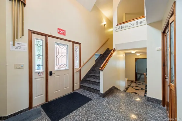a view of a big room with wooden floor and windows