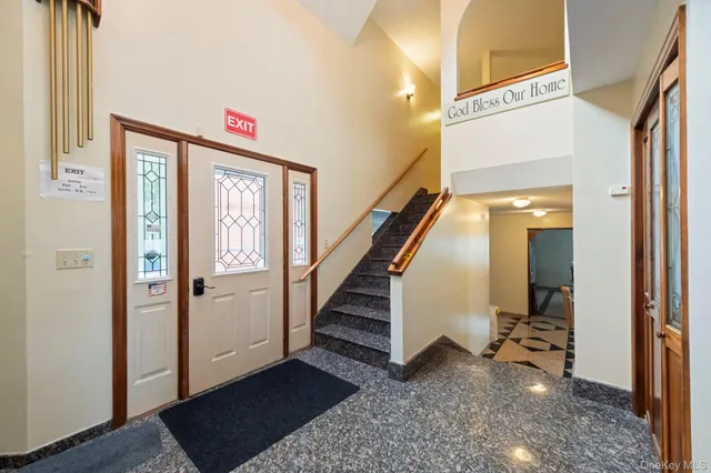 a view of a big room with wooden floor and windows