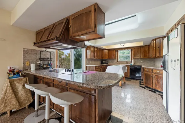 a kitchen with stainless steel appliances granite countertop a stove and a refrigerator