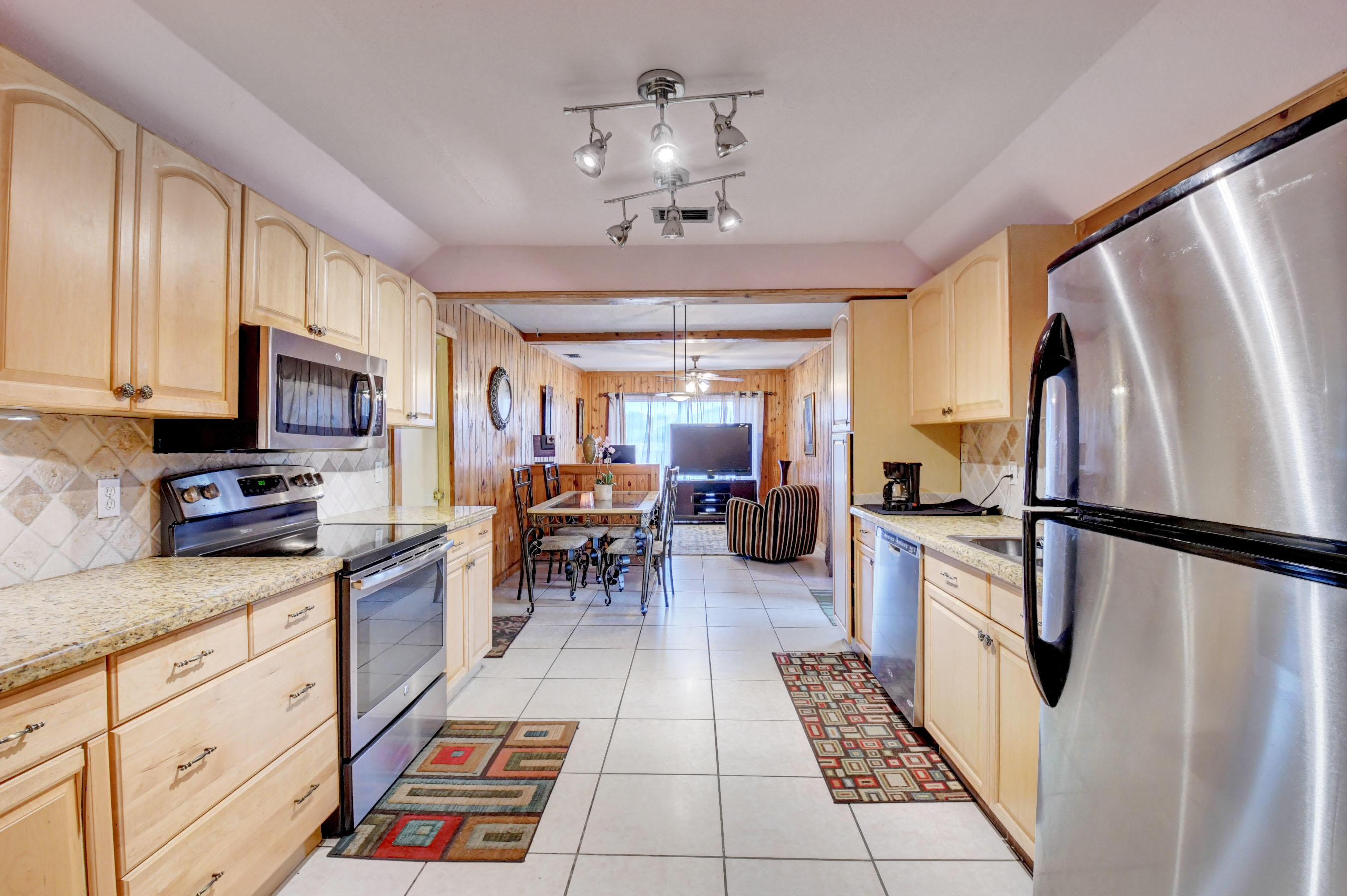 22790 Southwest 65th Avenue Boca Raton, FL 33428 - Photo 10 of 27 a kitchen with granite countertop stainless steel appliances a stove refrigerator and microwave
