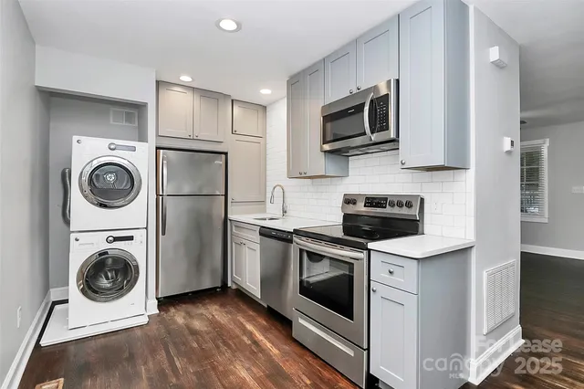 a kitchen with a stove top oven sink and refrigerator