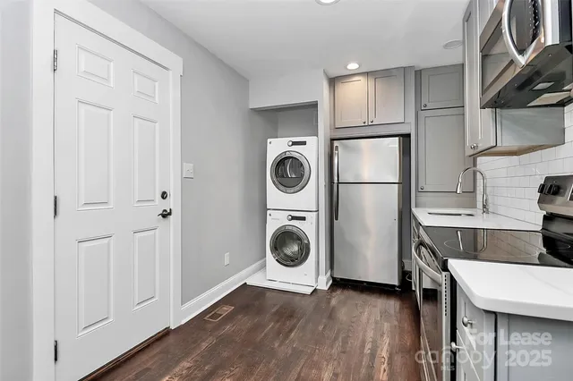 a kitchen with a refrigerator a stove and cabinets