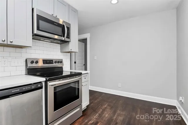 a kitchen with a stove and a microwave