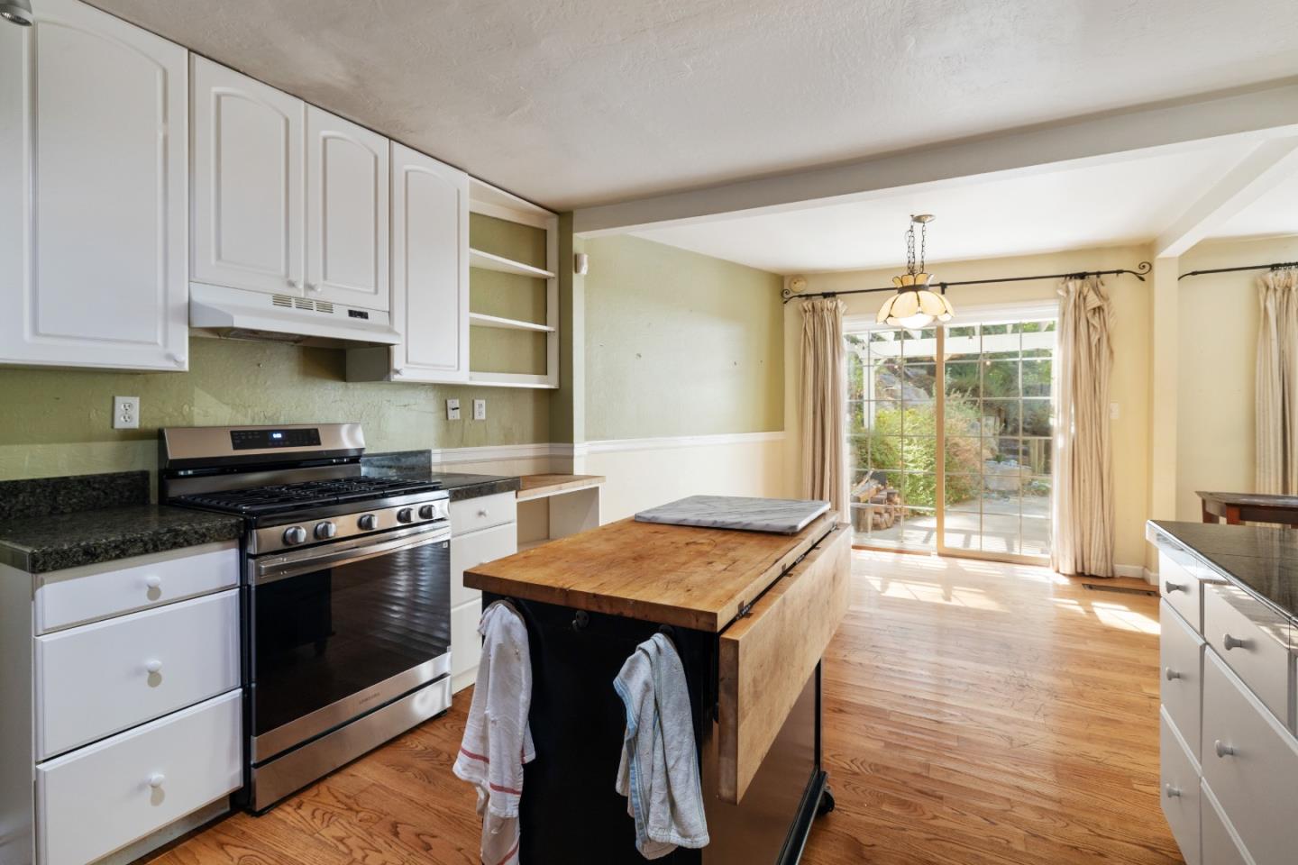 600 Cook Way Ben Lomond, CA 95005 - Photo 11 of 85 a kitchen with granite countertop a stove a sink and white cabinets with wooden floor