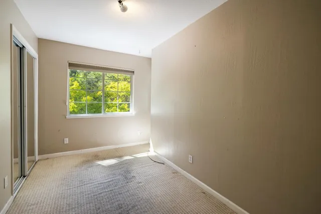 a bathroom with a granite countertop toilet a sink and a mirror