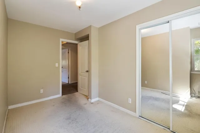 a bathroom with a granite countertop toilet a sink and a mirror