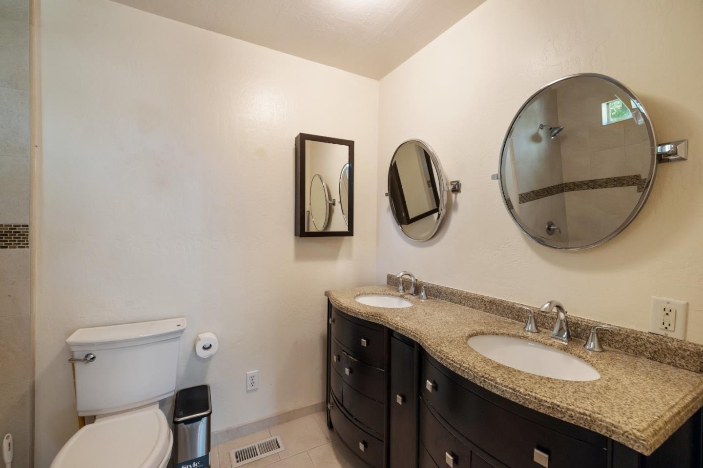 600 Cook Way Ben Lomond, CA 95005 - Photo 24 of 85 a bathroom with a granite countertop toilet a sink and a mirror