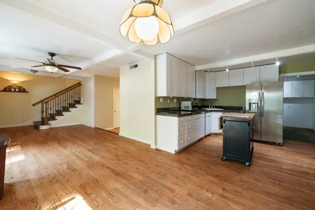 a kitchen with a refrigerator and a sink