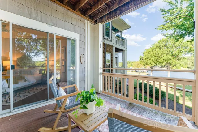 a porch with a bench next to a yard