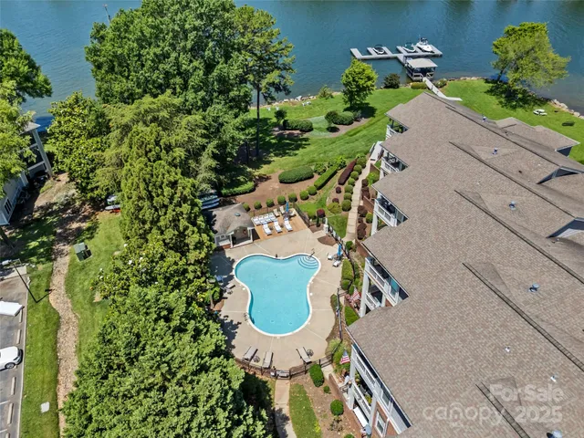 an aerial view of a house with a yard and swimming pool