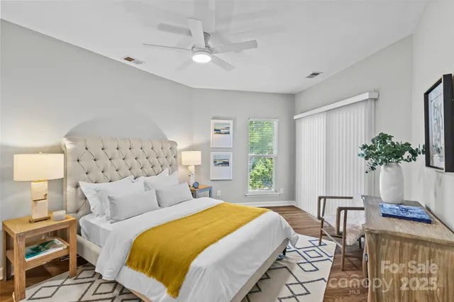a bedroom with a bed and a potted plant