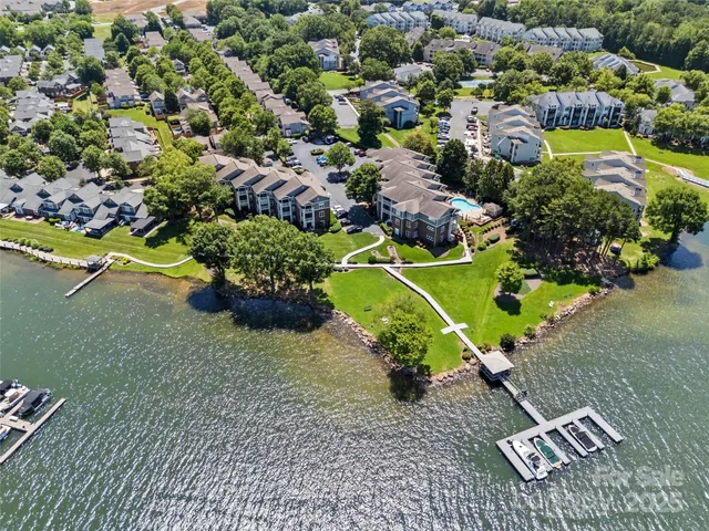 an aerial view of a house with a garden and swimming pool