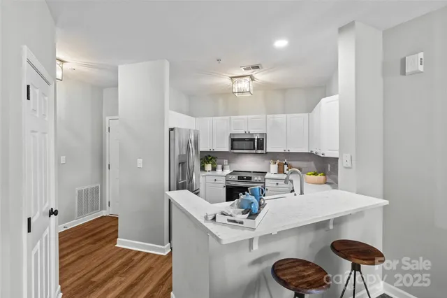 a kitchen with refrigerator and microwave