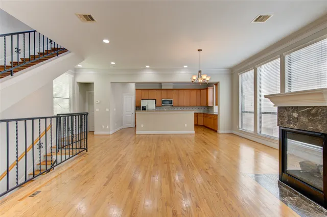 a view of a kitchen with wooden floor and a sink