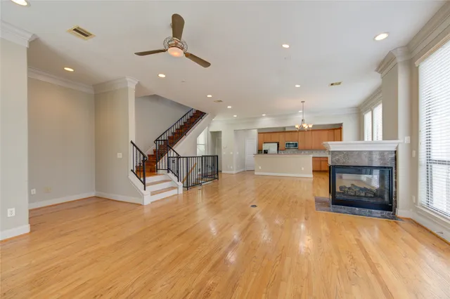 a living room with a fireplace and kitchen view