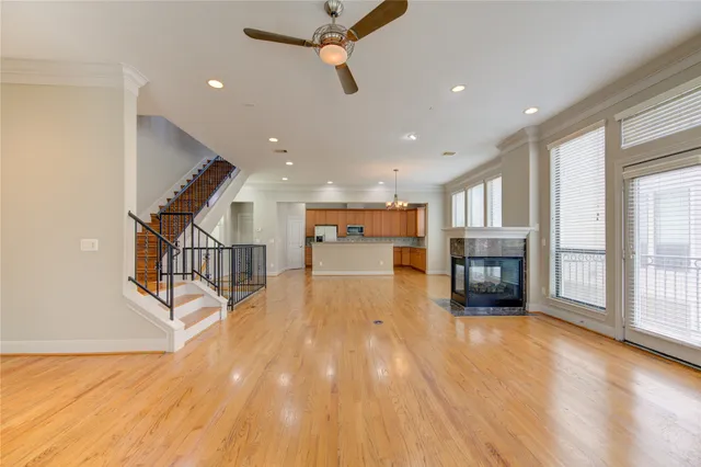 a view of a hallway with wooden floor and staircase