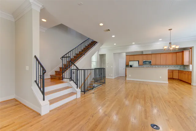 a view of kitchen and hall with wooden floor
