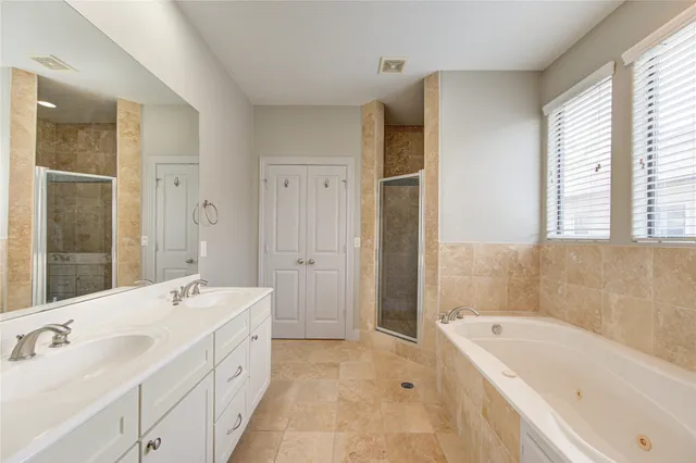 a bathroom with a tub sink and mirror