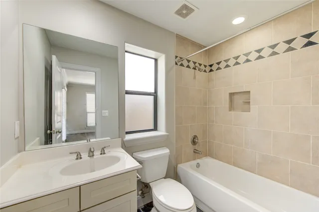 a bathroom with a sink mirror toilet and bathtub