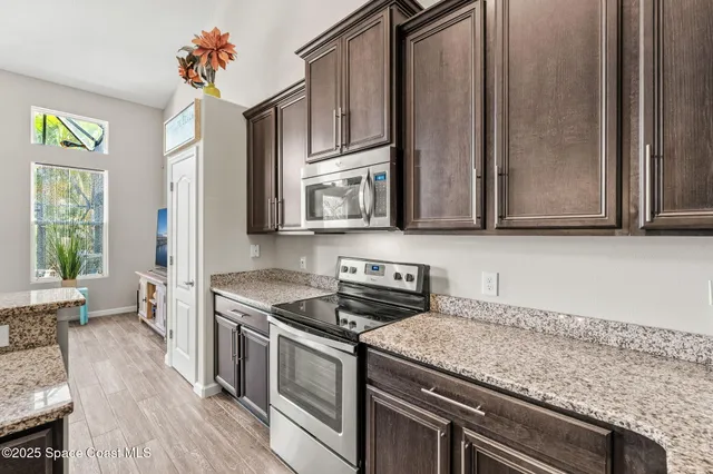 a kitchen with a stove and a refrigerator