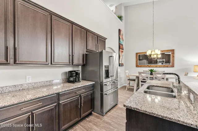 a kitchen with stainless steel appliances granite countertop a refrigerator stove and oven
