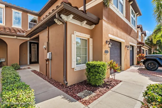 a view of a house with a small yard and plants
