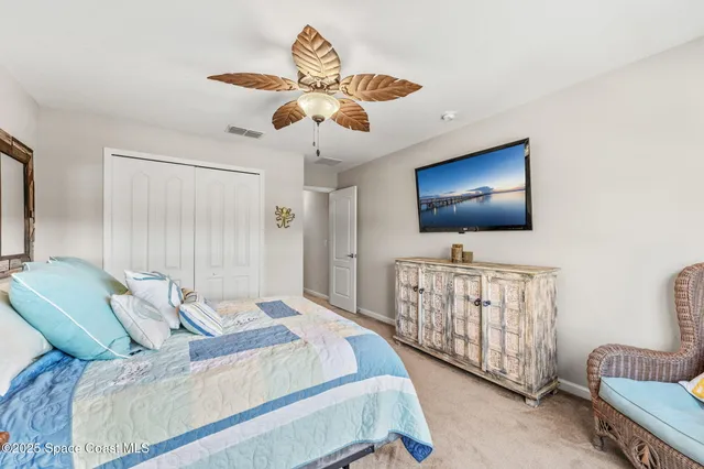 a view of a yard with plants and large trees