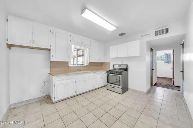 a kitchen with granite countertop cabinets and white stainless steel appliances