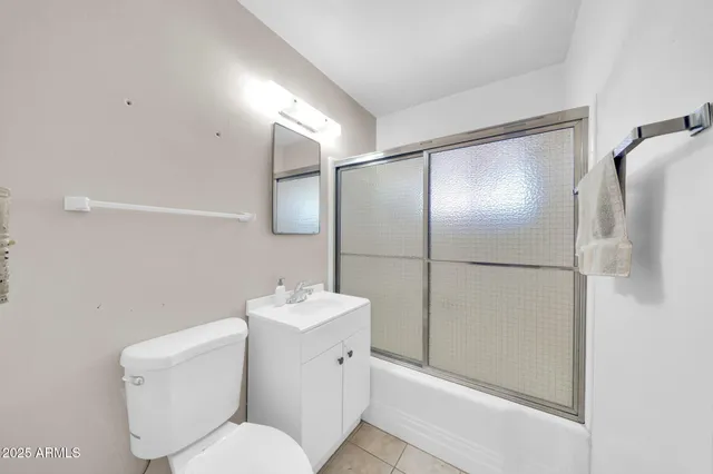 a bathroom with a toilet sink and shower