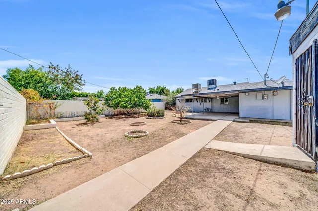 a house with yard and a wooden fence