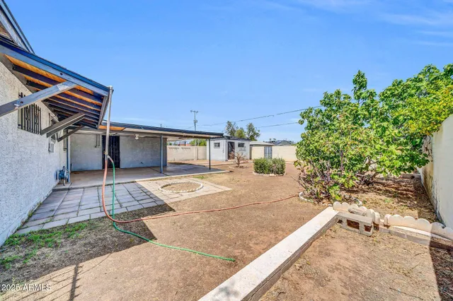 a view of a backyard with sitting area