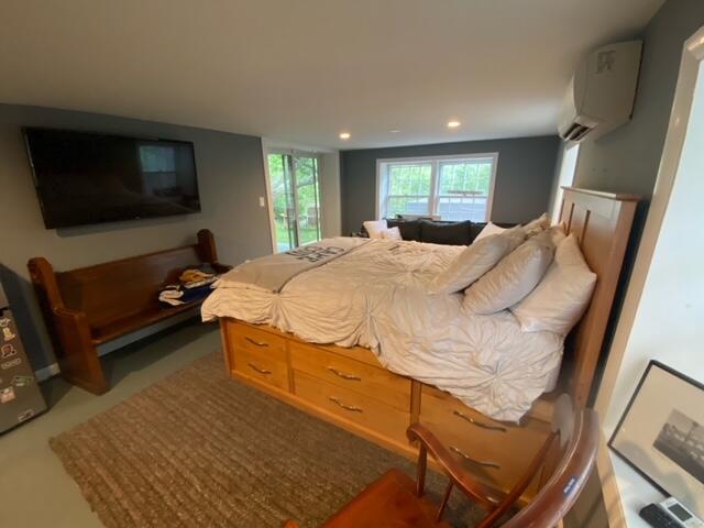 27 Uncatena Road Mashpee, MA 02649 - Photo 32 of 50 a bedroom with a bed and a flat screen tv