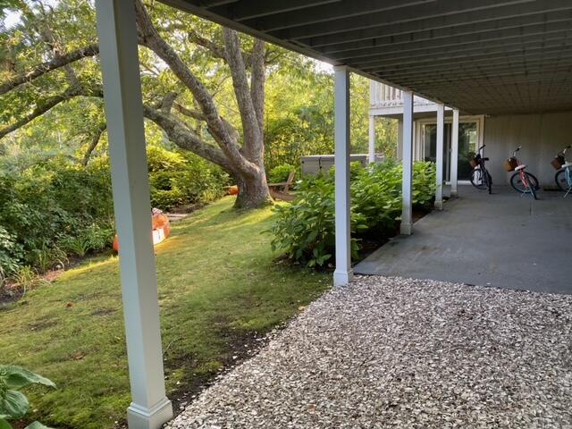 27 Uncatena Road Mashpee, MA 02649 - Photo 8 of 50 a view of a porch with furniture and garden