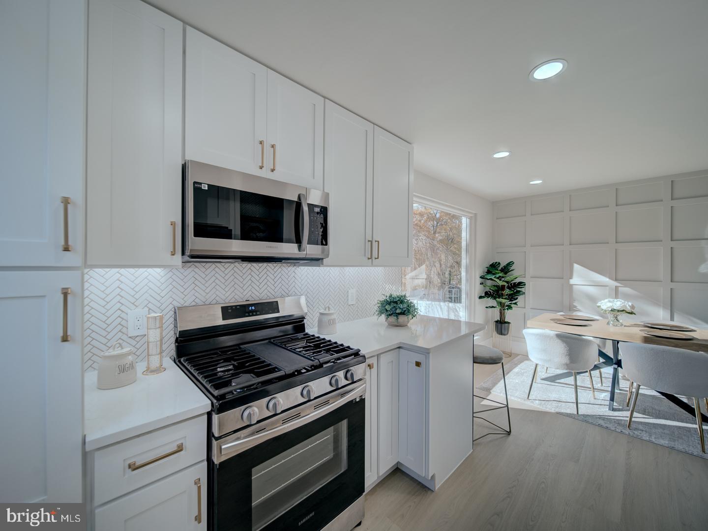 2906 Radius Road Silver Spring, MD 20902 - Photo 12 of 43 a kitchen with granite countertop a stove and a white cabinets