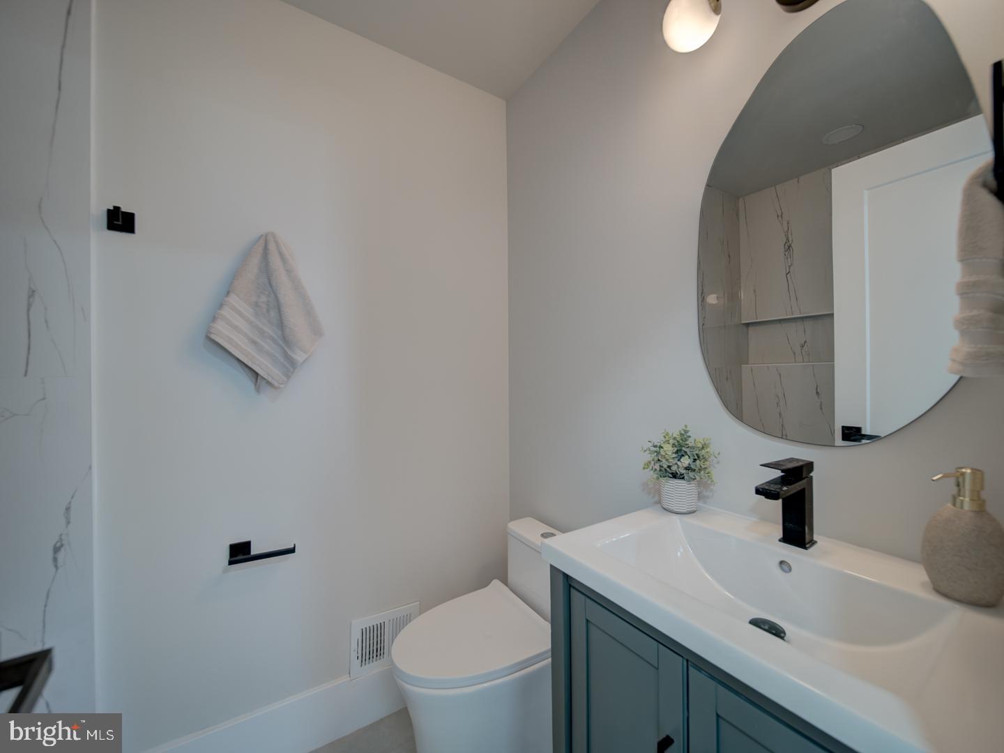 2906 Radius Road Silver Spring, MD 20902 - Photo 14 of 43 a bathroom with a sink toilet and mirror