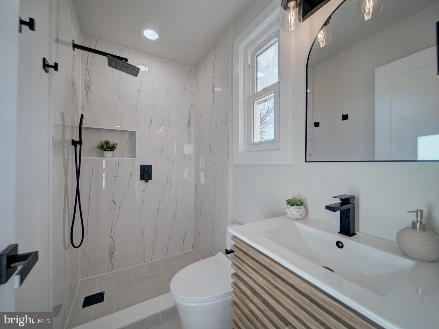 2906 Radius Road Silver Spring, MD 20902 - Photo 19 of 43 a bathroom with a sink a toilet and shower