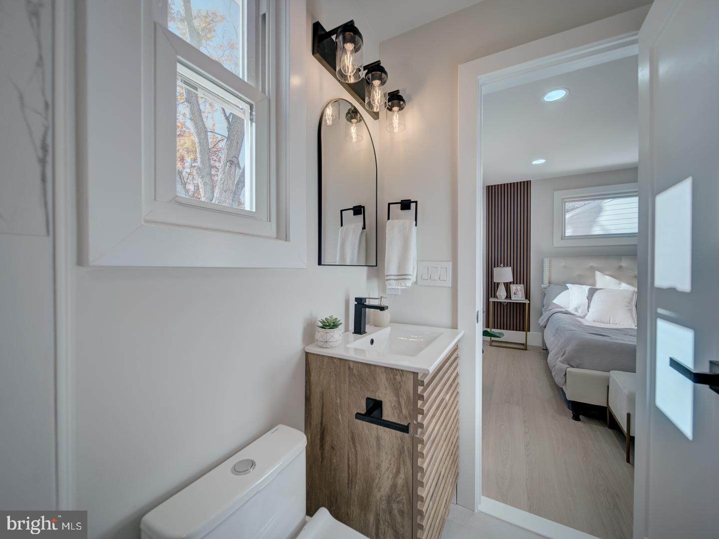 2906 Radius Road Silver Spring, MD 20902 - Photo 20 of 43 a bathroom with a toilet sink and mirror