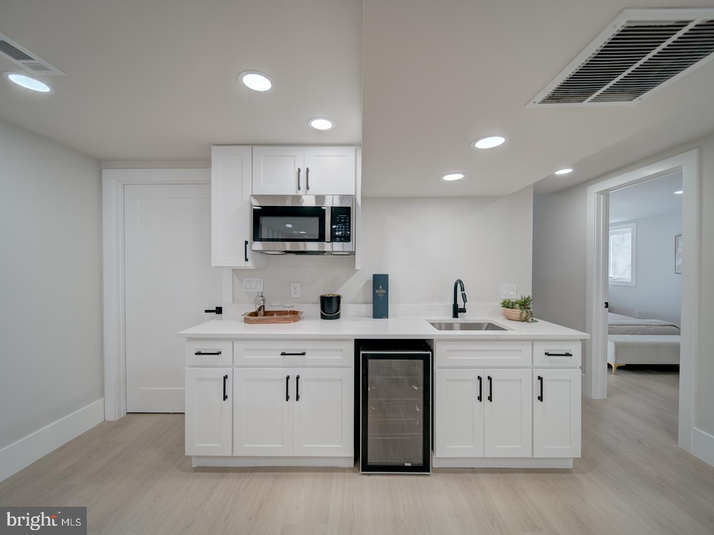 2906 Radius Road Silver Spring, MD 20902 - Photo 31 of 43 a kitchen with a sink stove and cabinets