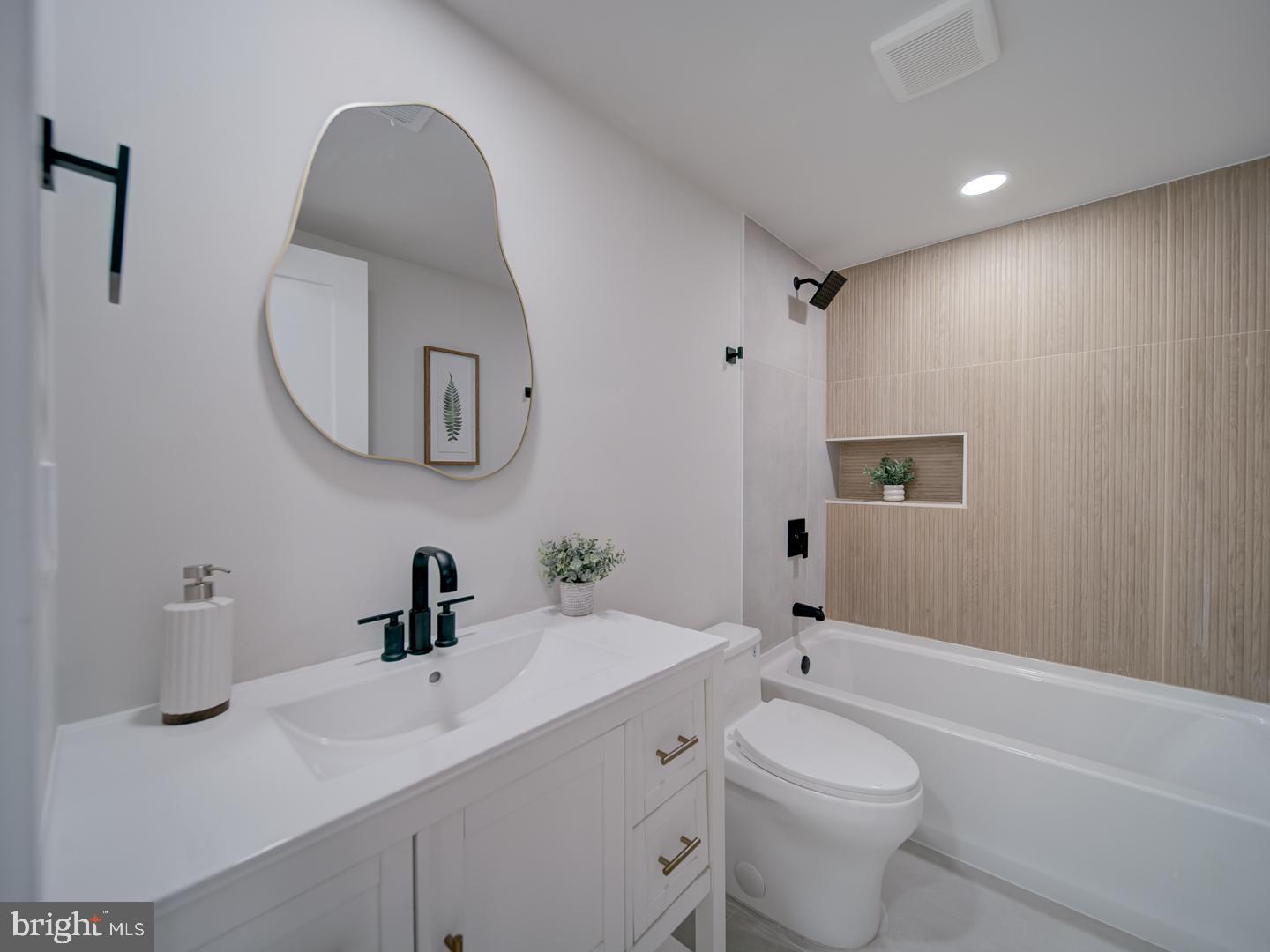 2906 Radius Road Silver Spring, MD 20902 - Photo 36 of 43 a bathroom with a toilet a sink a mirror and bathtub