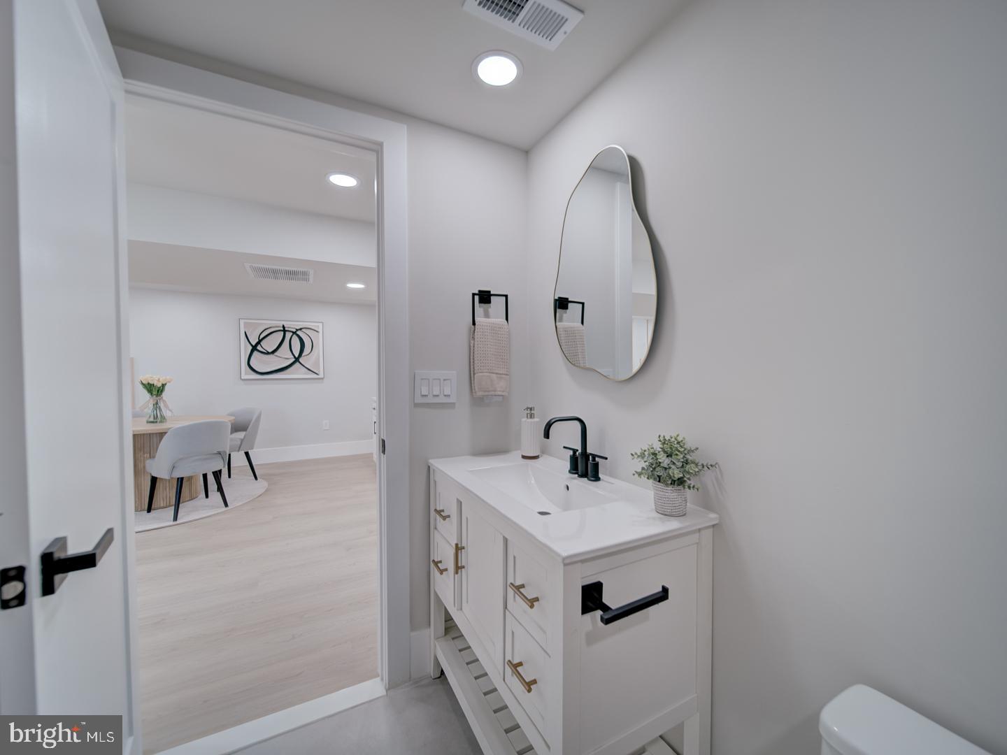 2906 Radius Road Silver Spring, MD 20902 - Photo 37 of 43 a spacious bathroom with a double vanity sink and a mirror