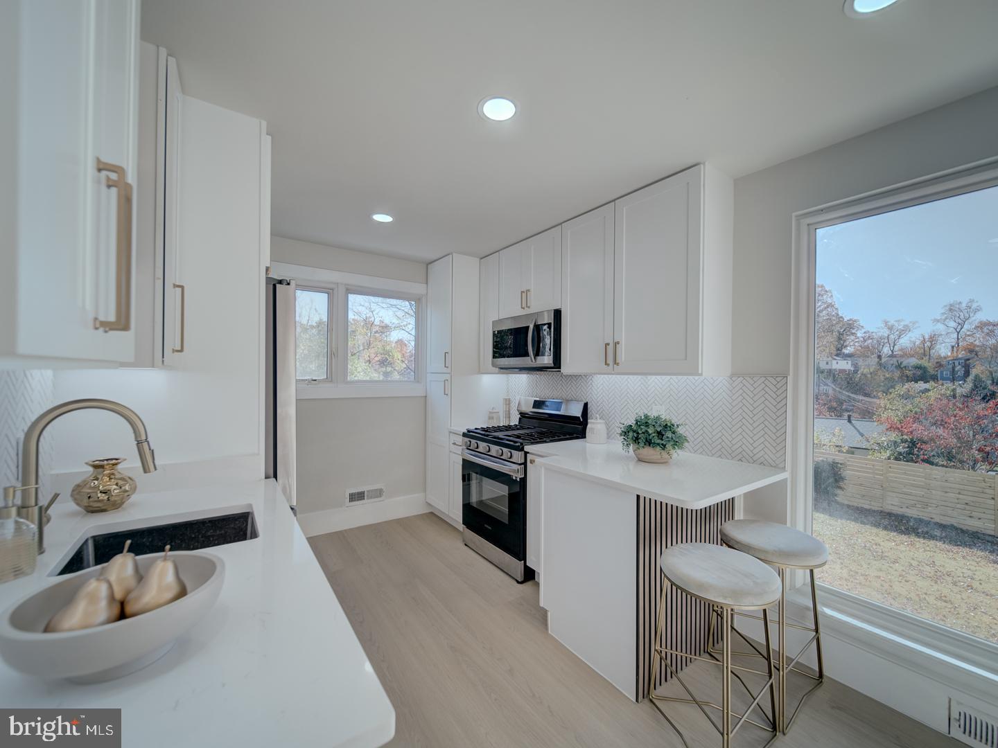 2906 Radius Road Silver Spring, MD 20902 - Photo 9 of 43 a kitchen with granite countertop a sink stainless steel appliances and cabinets