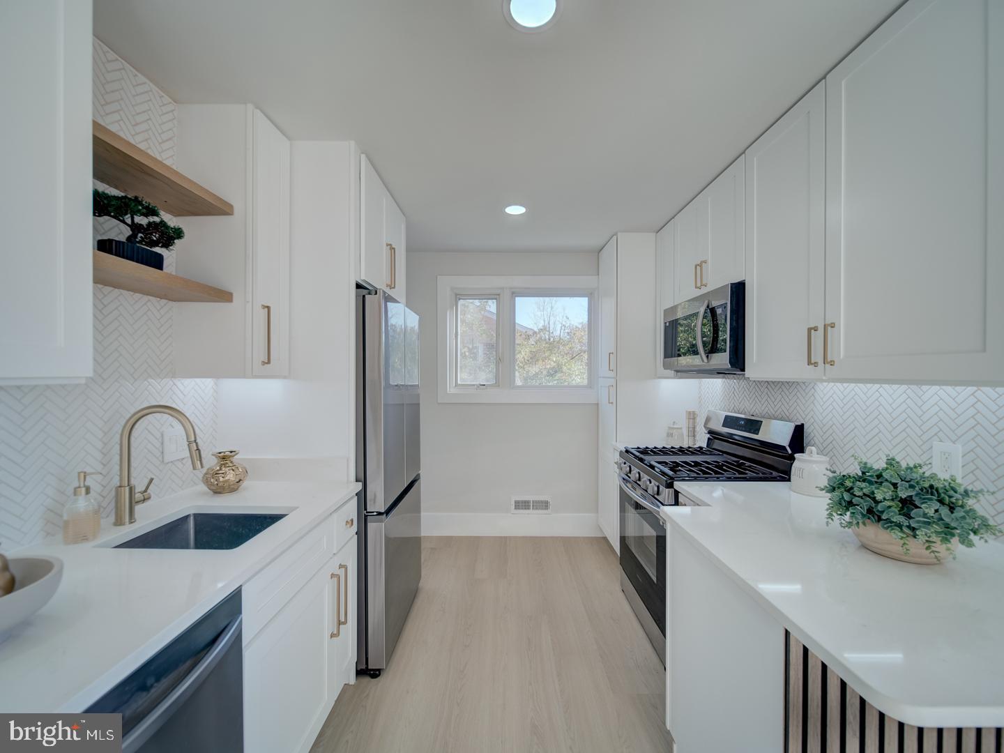 2906 Radius Road Silver Spring, MD 20902 - Photo 10 of 43 a kitchen with stainless steel appliances a sink stove and refrigerator