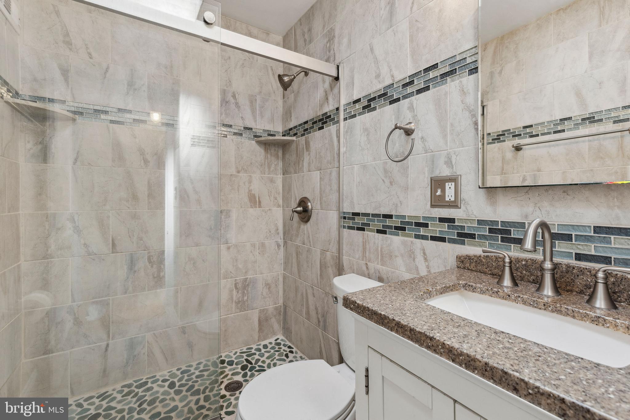 3418 Dunran Road Baltimore, MD 21222 - Photo 13 of 19 a bathroom with a granite countertop sink toilet and shower